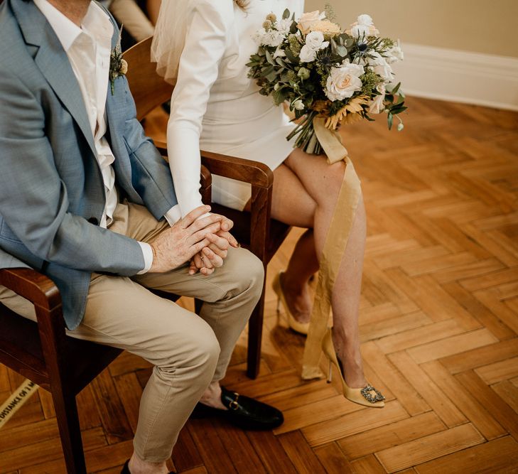 Bride and Groom holding hands during Town Hall wedding ceremony