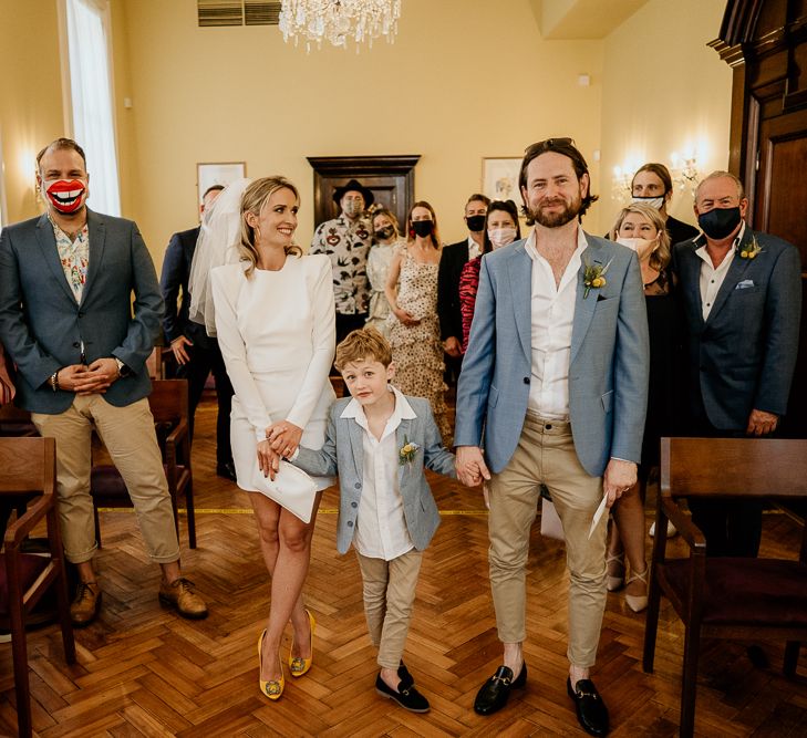 Bride and Groom with their son exiting the wedding ceremony