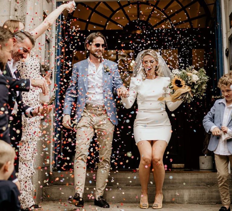 Confetti moment with bride in short wedding dress