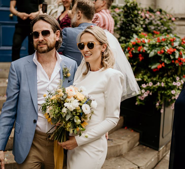 Stylish bride and groom in sunglasses at Intimate London wedding