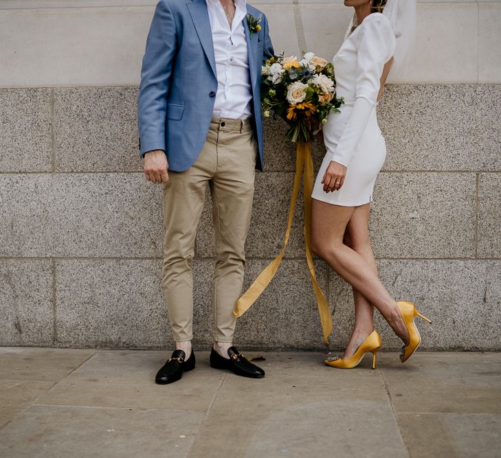 bride in short wedding dress with yellow shoes and groom in chinos and loafers