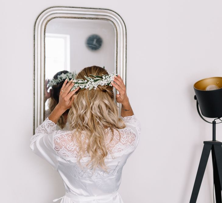 Wedding Morning Bridal Preparations with Bride in Getting Ready Rob Adjusting Her Flower Crown