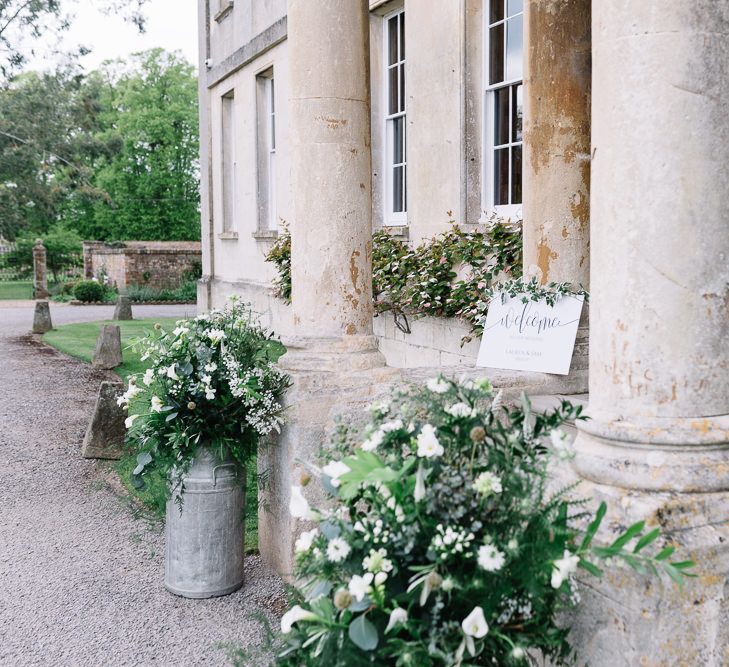 White and Green Flower Filled Milk Churns