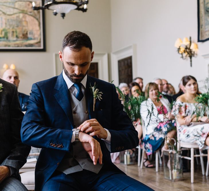 Groom in Bespoke Navy Check Suit at the Altar Checking His Watch