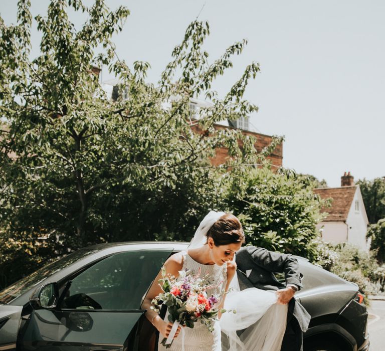 Bride in pink wedding shoes with bright bouquet