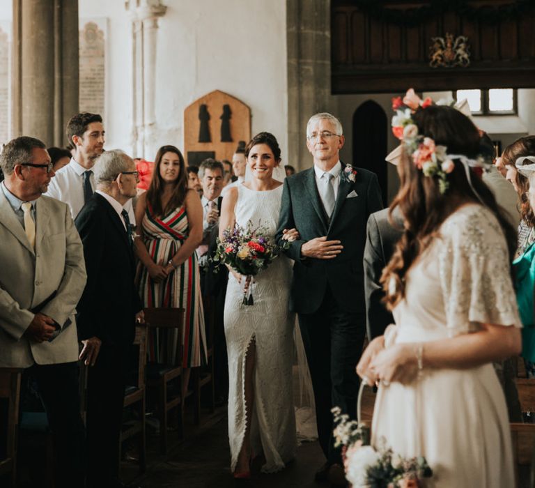 Bride walks down the aisle at church ceremony