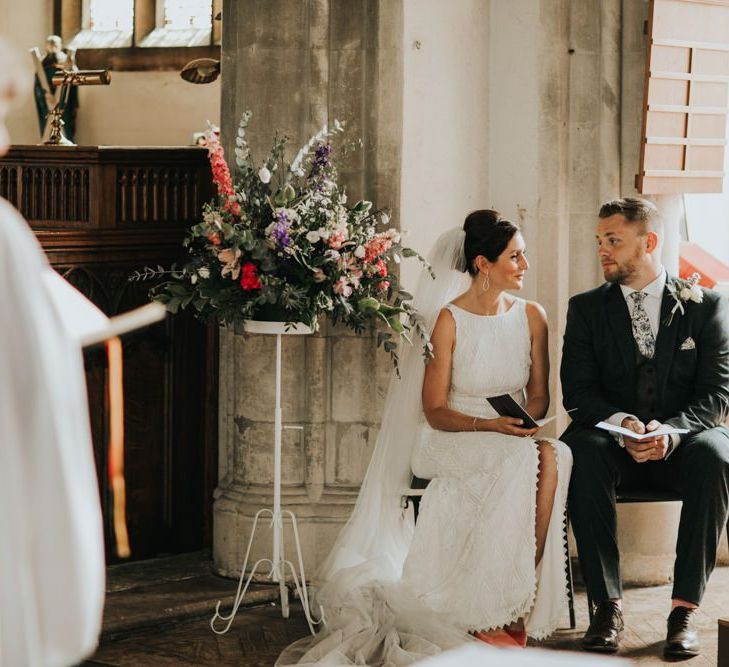 Bride and groom at church wedding with different bridesmaid dresses