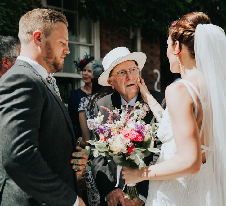 Bride and groom greet wedding guests