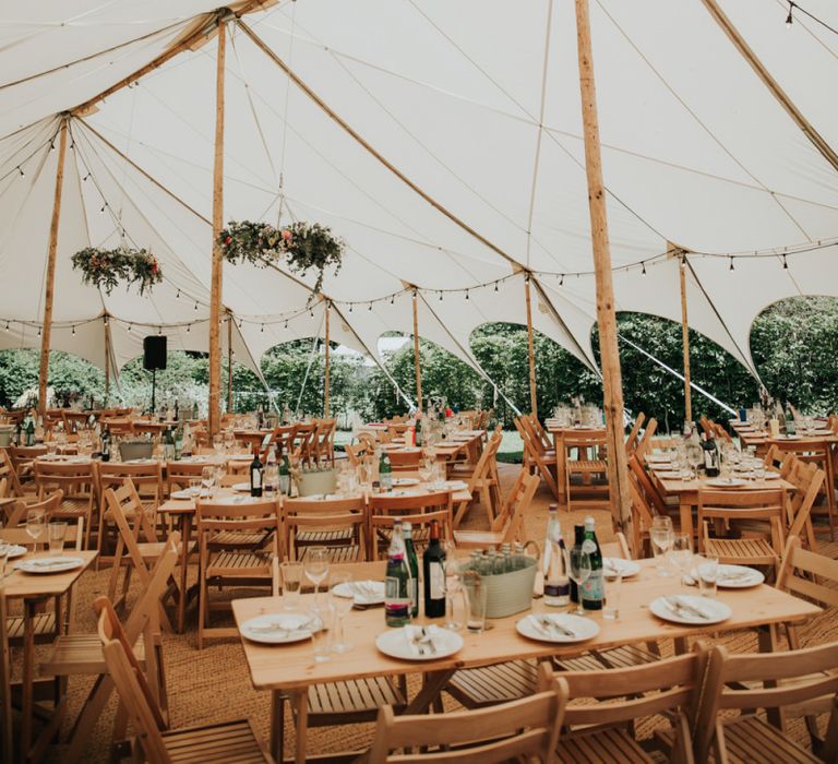 Marquee wedding in garden at home with different bridesmaid dresses