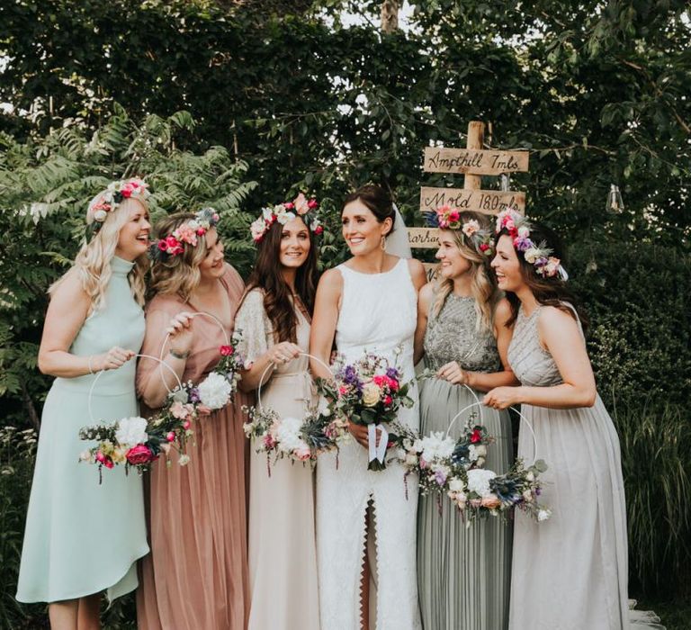 Bridal party in different bridesmaid dresses with hoop bouquets