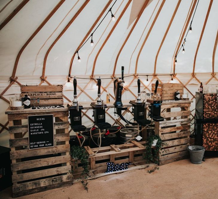 Rustic wedding bar in marquee