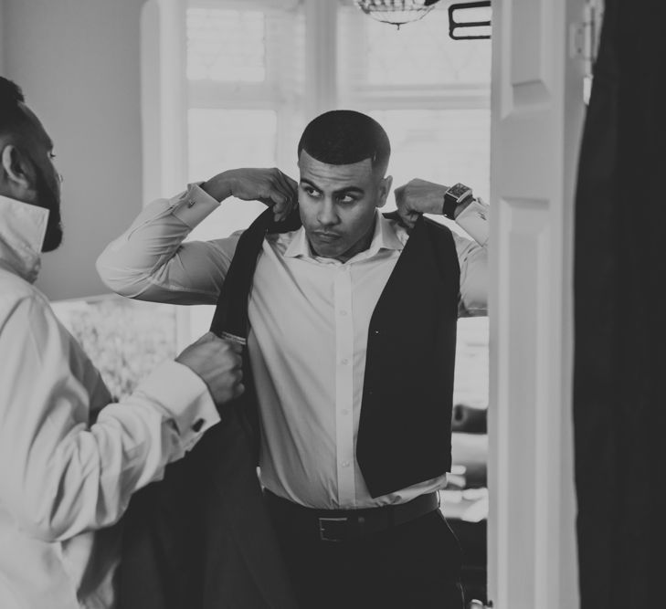 Groom Getting Ready in Navy Ted Baker Suit from Moss Bros. | Pink Roll Top Booze Bath and Copper &amp; Perspex Wedding Decor at Industrial Venue The West Mill | Rosie Kelly Photography