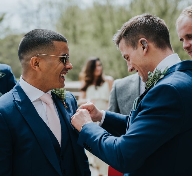 Groom in Navy Ted Baker Suit from Moss Bros. | Pink Roll Top Booze Bath and Copper &amp; Perspex Wedding Decor at Industrial Venue The West Mill | Rosie Kelly Photography