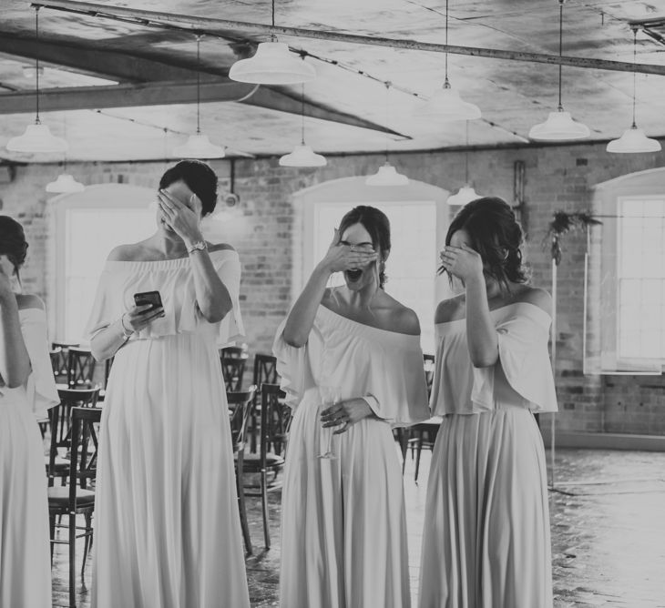 Bridesmaids in Off The Shoulder Green Sheln Dresses | Pink Roll Top Booze Bath and Copper &amp; Perspex Wedding Decor at Industrial Venue The West Mill | Rosie Kelly Photography