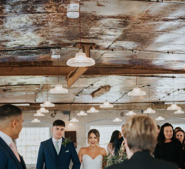 Wedding Ceremony Bridal Entrance  in Fishtail Allure Bridal Gown | Pink Roll Top Booze Bath and Copper &amp; Perspex Wedding Decor at Industrial Venue The West Mill | Rosie Kelly Photography