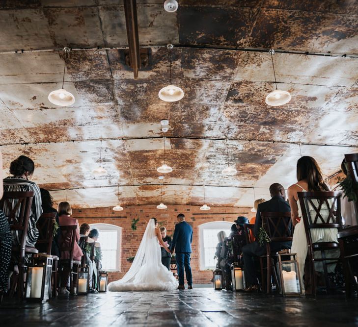 Wedding Ceremony | Bride in Allure Bridal Gown | Groom in Navy Ted Baker Suit | Pink Roll Top Booze Bath and Copper &amp; Perspex Wedding Decor at Industrial Venue The West Mill | Rosie Kelly Photography