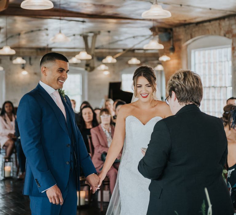 Wedding Ceremony | Bride in Fishtail Allure Bridal Gown | Groom in Navy Ted Baker Suit | Pink Roll Top Booze Bath and Copper &amp; Perspex Wedding Decor at Industrial Venue The West Mill | Rosie Kelly Photography