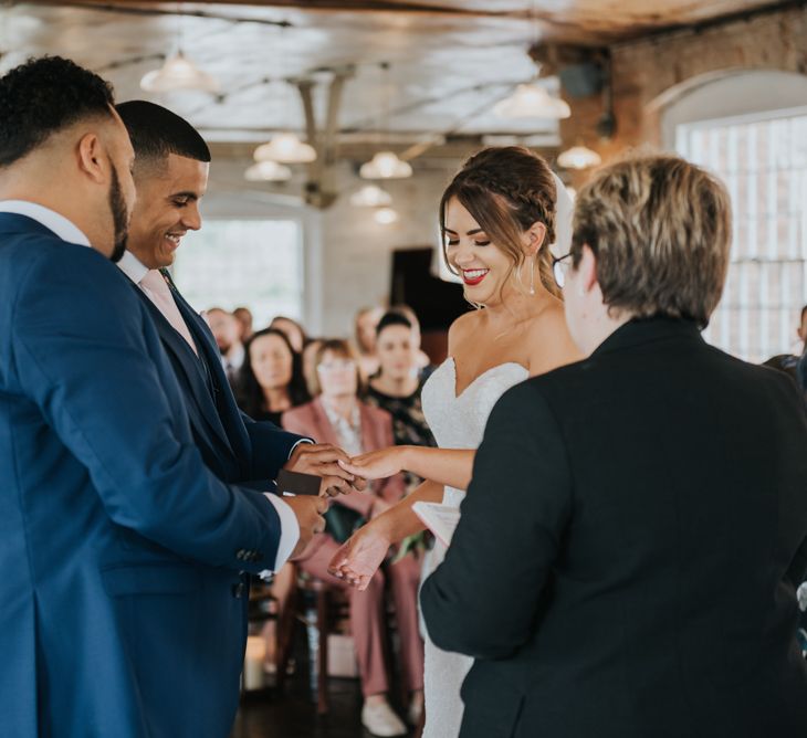 Wedding Ceremony | Bride in Fishtail Allure Bridal Gown | Groom in Navy Ted Baker Suit | Pink Roll Top Booze Bath and Copper &amp; Perspex Wedding Decor at Industrial Venue The West Mill | Rosie Kelly Photography