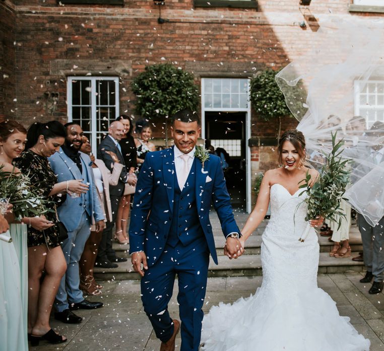 Confetti Exit | Bride in Fishtail Allure Bridal Gown | Groom in Navy Ted Baker Suit | Pink Roll Top Booze Bath and Copper &amp; Perspex Wedding Decor at Industrial Venue The West Mill | Rosie Kelly Photography