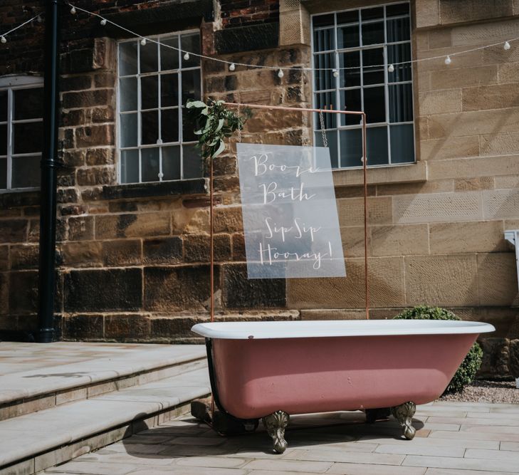 Pink Roll Top Booze Bath and Copper &amp; Perspex Wedding Sign | Industrial Venue The West Mill | Rosie Kelly Photography