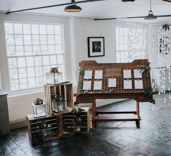 Wooden Crates, Lantern &amp; Copper Table Plan Wedding Decor | Pink Roll Top Booze Bath and Copper &amp; Perspex Wedding Decor at Industrial Venue The West Mill | Rosie Kelly Photography