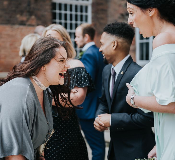 Wedding Guests | Pink Roll Top Booze Bath and Copper &amp; Perspex Wedding Decor at Industrial Venue The West Mill | Rosie Kelly Photography