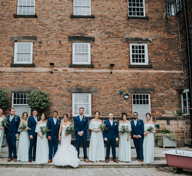 Wedding Party | Bridesmaids in Mint Green Bardot Dresses from Sheln | Bride in Fishtail Allure Bridal Gown | Groomsmen in Navy Ted Baker Suits | Pink Roll Top Booze Bath and Copper &amp; Perspex Wedding Decor at Industrial Venue The West Mill | Rosie Kelly Photography