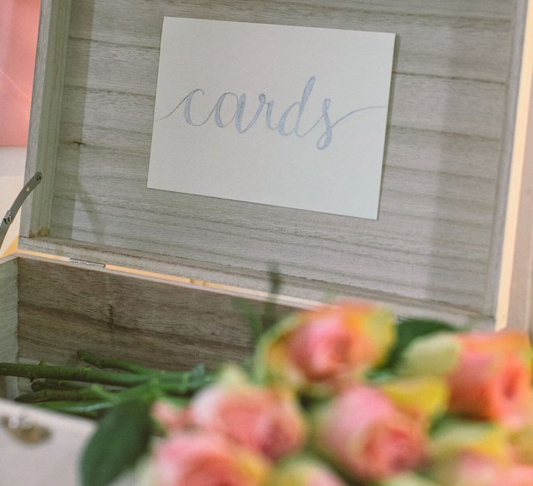 Wedding card box created out of a simple pale wooden box and the word 'Cards' brush lettered onto it in silver pen