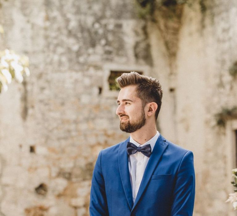 Blue wedding suit for groom with bow tie