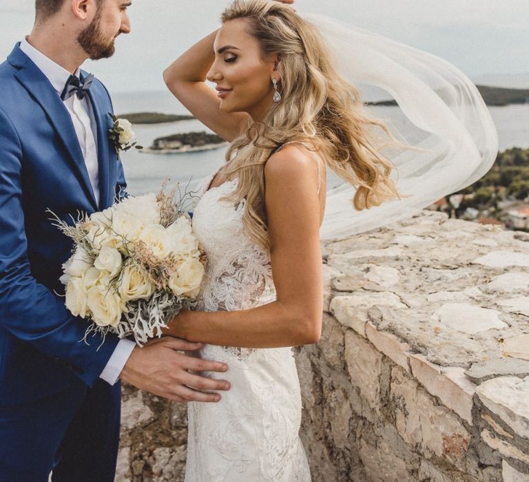 Bride wears hair in Hollywood waves with veil