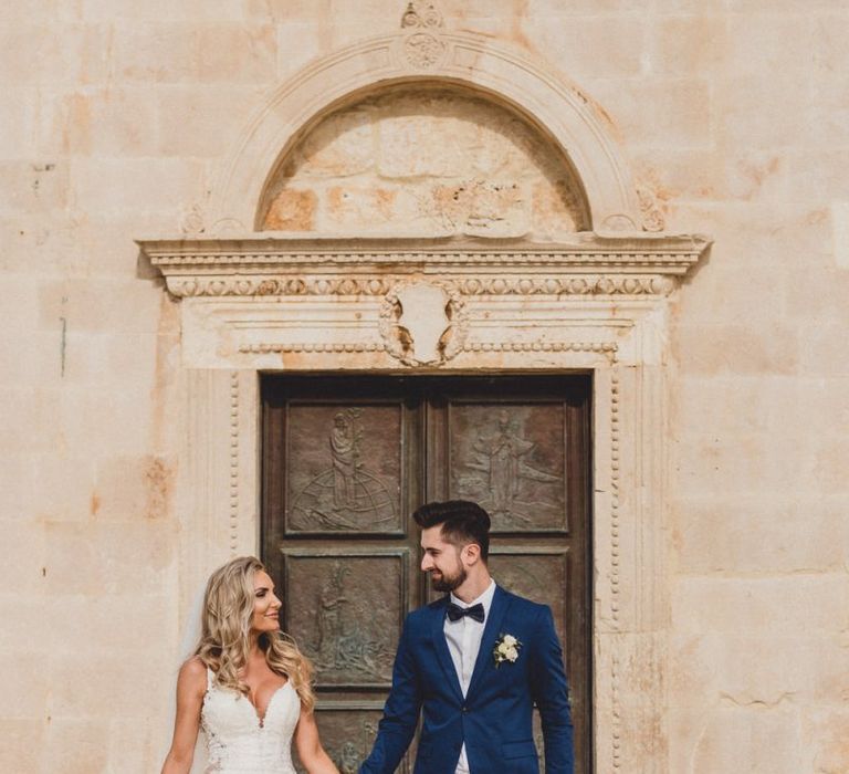 Bride in Essense of Australia wedding dress with groom in blue suit