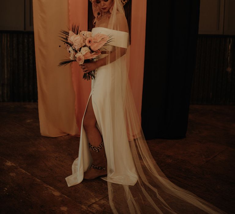 Bride in strapless wedding dress with cathedral length veil