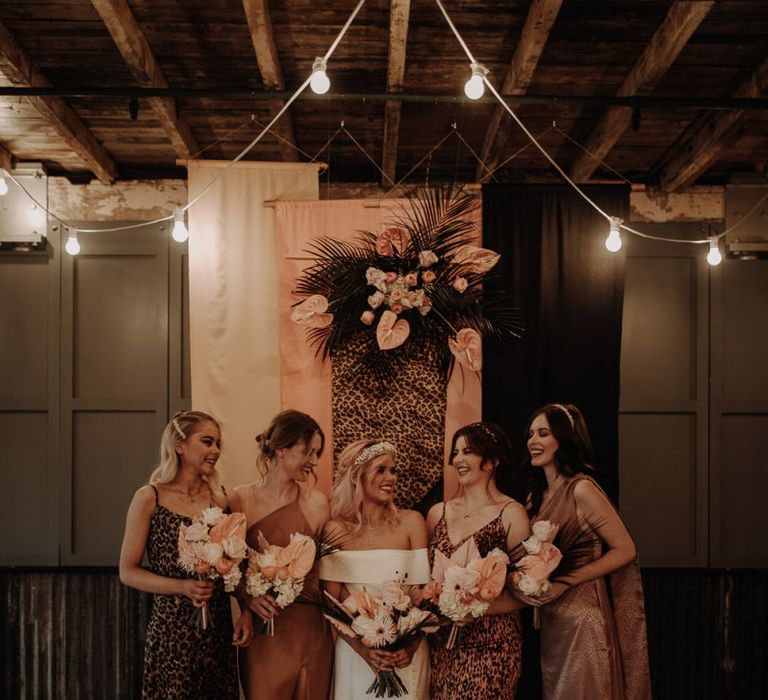 Stylish bridal party portrait with leopard print bridesmaid dresses