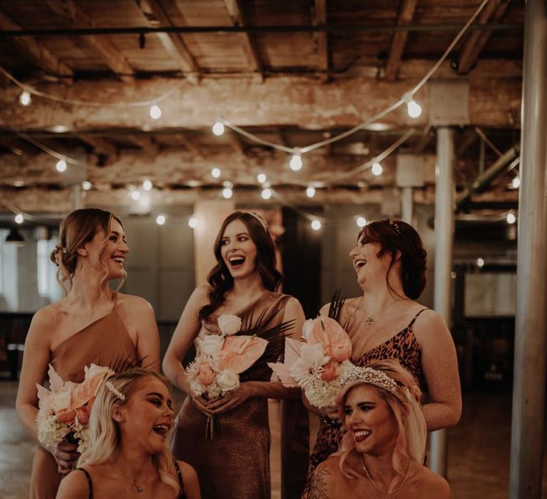 bridal party laughing in leopard print bridesmaid dresses