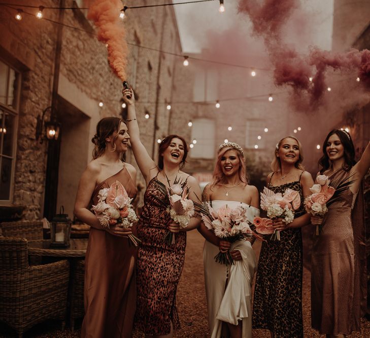 Bridal party smoke bomb portrait with leopard print bridesmaid dresses