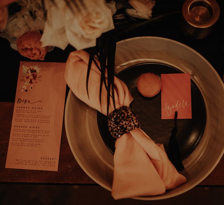 Place setting with serving platter and leopard print napkin ring