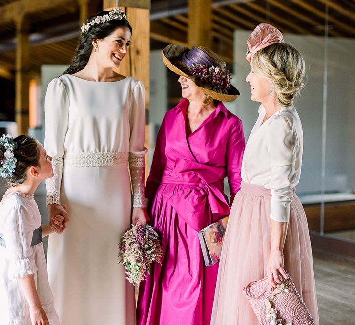 Bridal party portrait with guests in pink dresses and bride holding a astilbe wedding bouquet