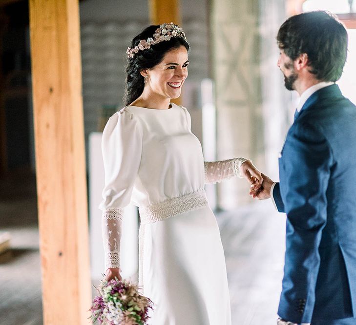 Bride and groom first look with bride in Victoria Imaz wedding dress holding a astilbe wedding bouquet