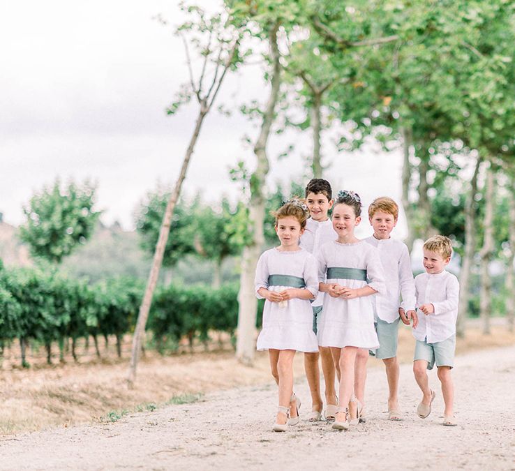 Flower girls and page boys in white and green outfits