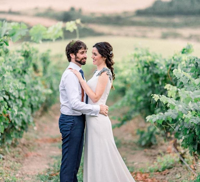 Bride in silk wedding dress with embellished shoulder detail