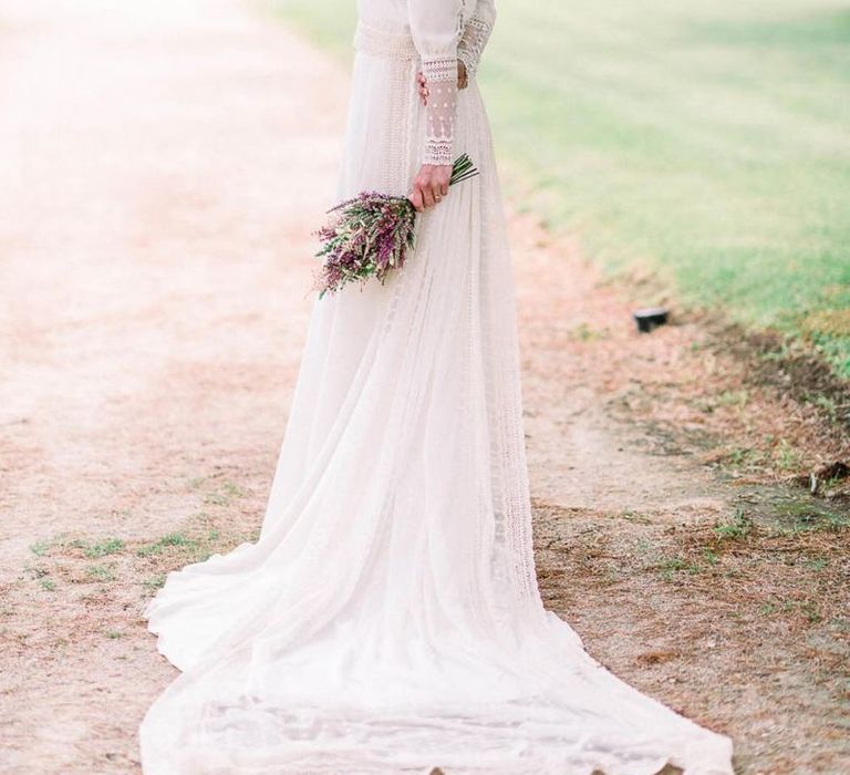 Victoria Imaz wedding dress with lace cuffs and long detachable train holding an astilbe wedding bouquet