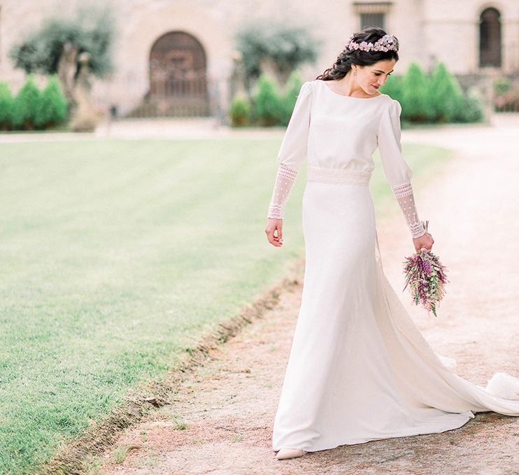 Bride in Victoria Imaz wedding dress holding an astilbe wedding bouquet