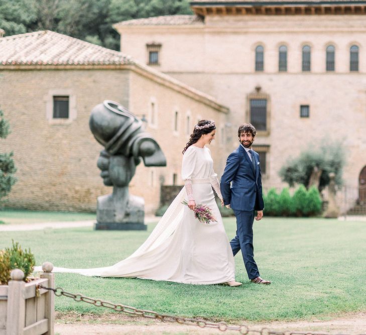 Bride and groom at Otazu Wineries wedding venue with bride holding an astilbe wedding bouquet