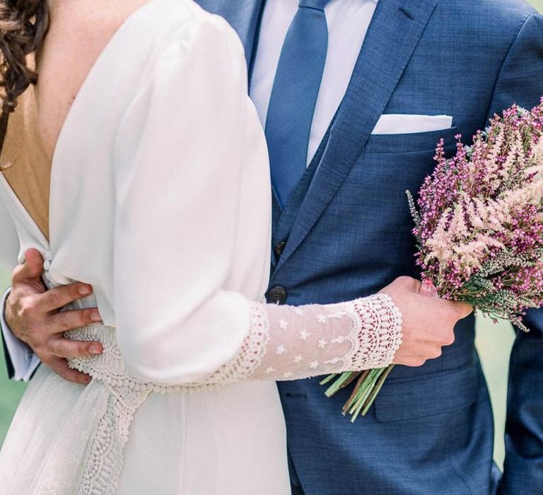 Bride with French plait holding an astilbe wedding bouquet