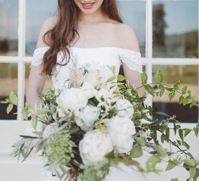 Bride in Bardot Off The Shoulder Wedding Dress &amp; Hermione Harbutt Headdress | L'heure Opulente - Laid Back French Chic, Paired with Elegant British Twists by Simply Pergord Weddings at Le Jardin à La Française Chateau | Mathilde Dufraisse Photography