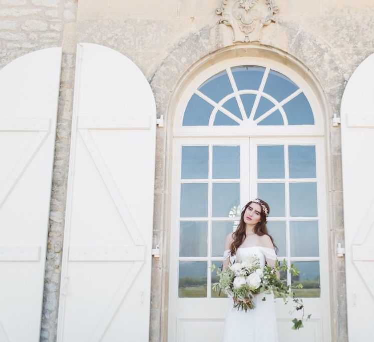 Bride in Bardot off the Shoulder Bridal Gown with Oversized  Bouquet | L'heure Opulente - Laid Back French Chic, Paired with Elegant British Twists by Simply Pergord Weddings at Le Jardin à La Française Chateau | Mathilde Dufraisse Photography