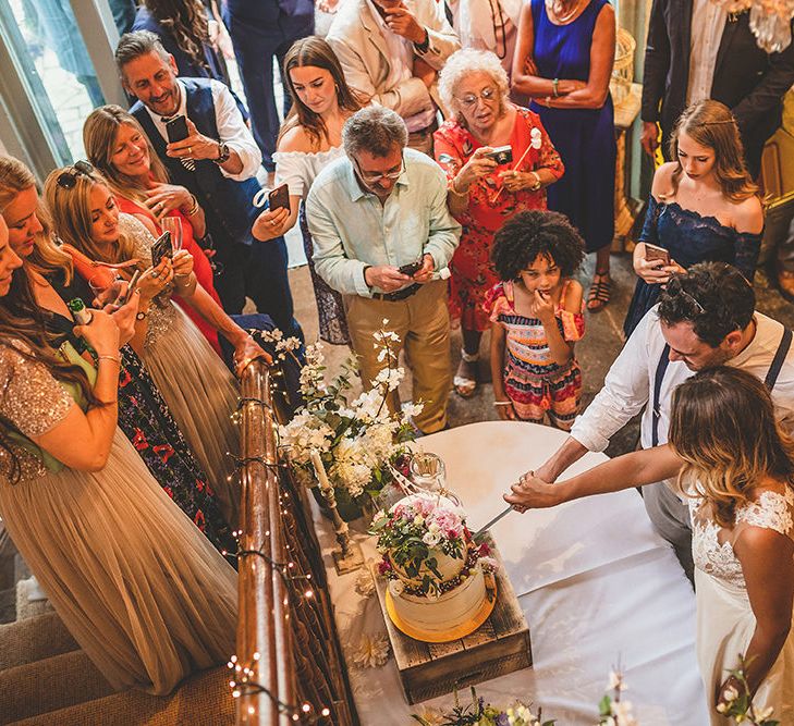 Bride &amp; Groom Cutting the Cake | Pennard House Outdoor Country Garden Wedding | Howell Jones Photography