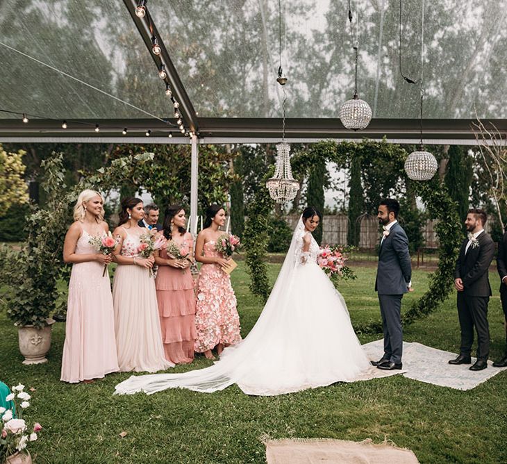 Wedding Ceremony | Glasshouse | Chandelier Altar | Wedding Party | Bride in Rosa Clara Gown | Groom in Black Tie | Bridesmaids in Different Blush Pink Dresses | Luxe Blush Pink Glasshouse Wedding at Cortal Gran, Spain Planned by La Puta Suegra  | Sara Lobla Photography