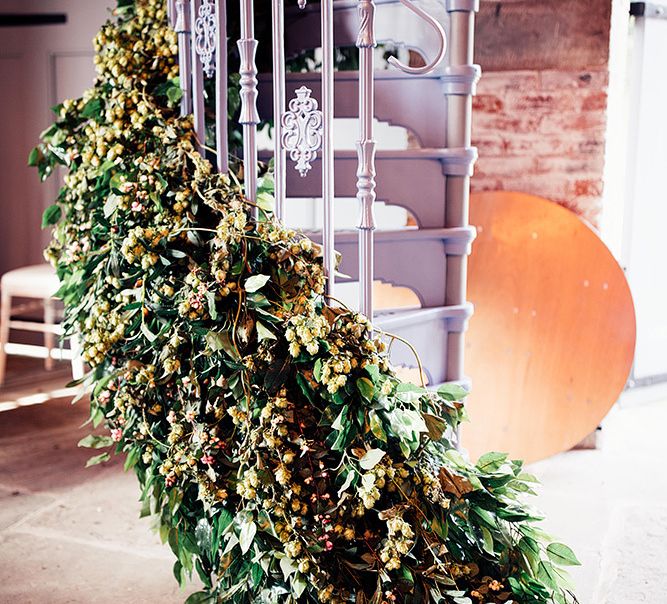 Flowers decorating the stairs at  Dorfold Hall wedding