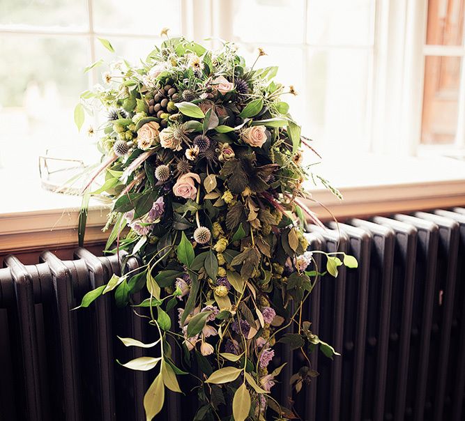 Cascading wedding bouquet with rose and foliage